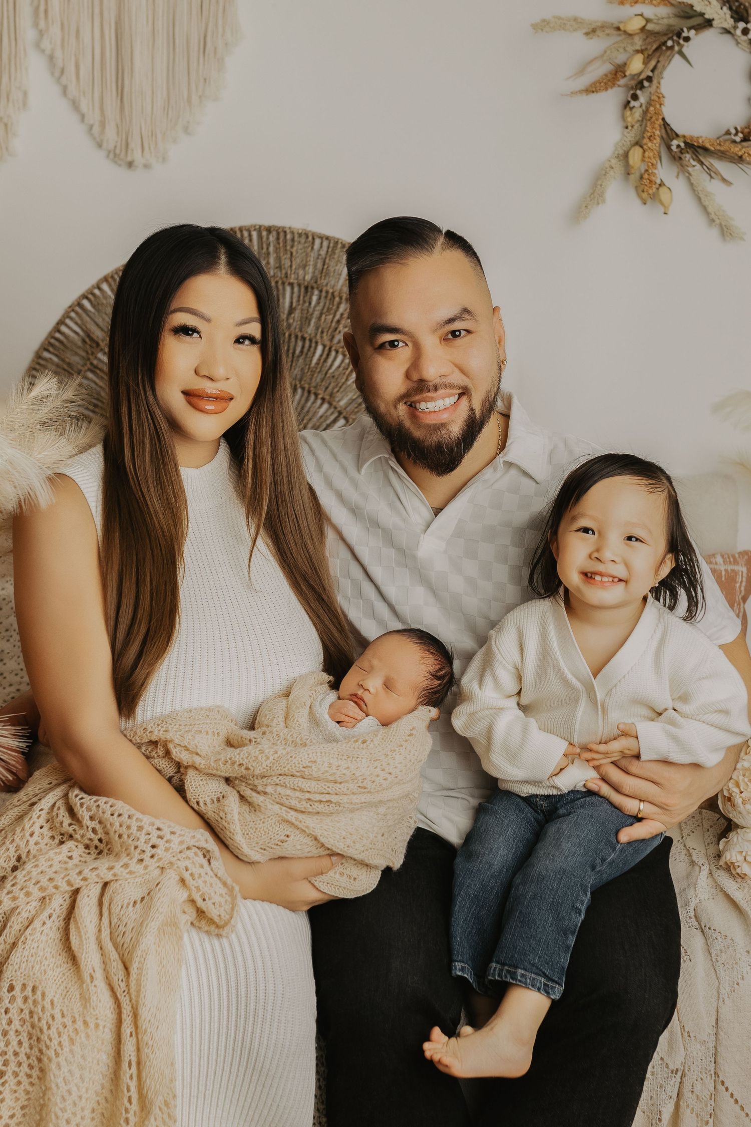 A modern family portrait with boho elements and neutral earth tones.
