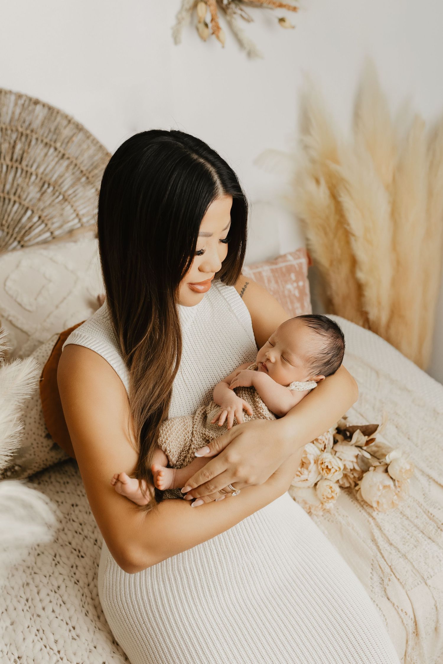 A tender moment captured in natural light with boho-inspired decor elements.