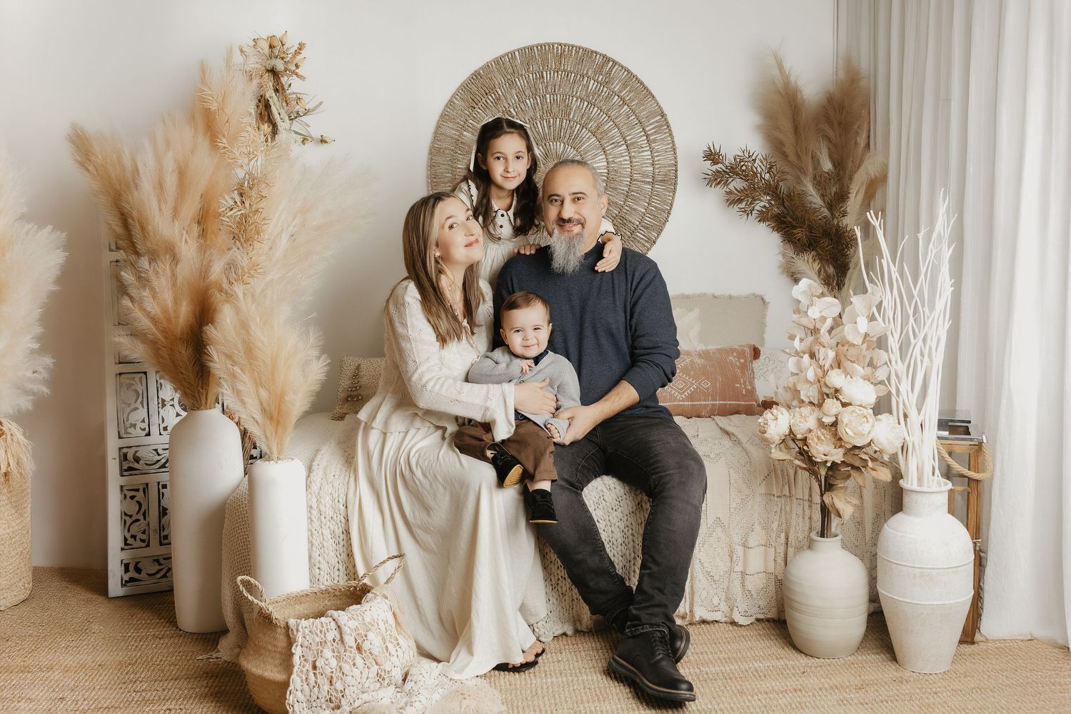 Candid family moments captured in light filled studio with natural decor.