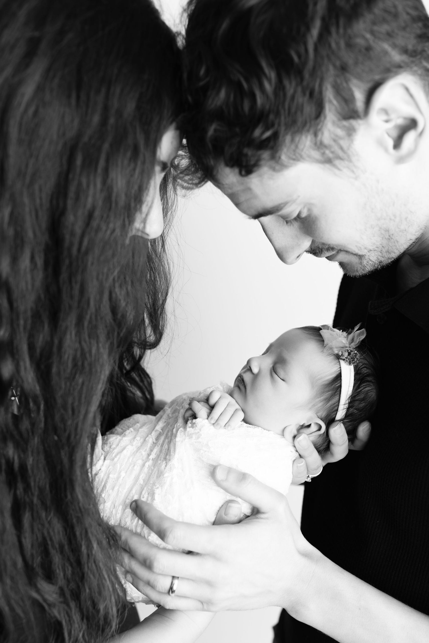 Black and white intimate family portrait series showing tender moments.