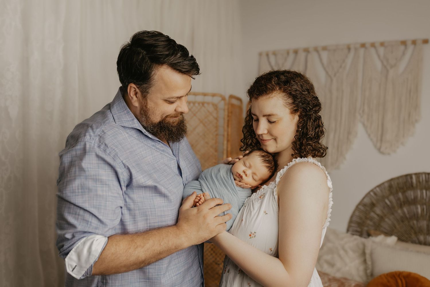 Series of intimate family portraits showing parents sharing tender moments with their newborn.