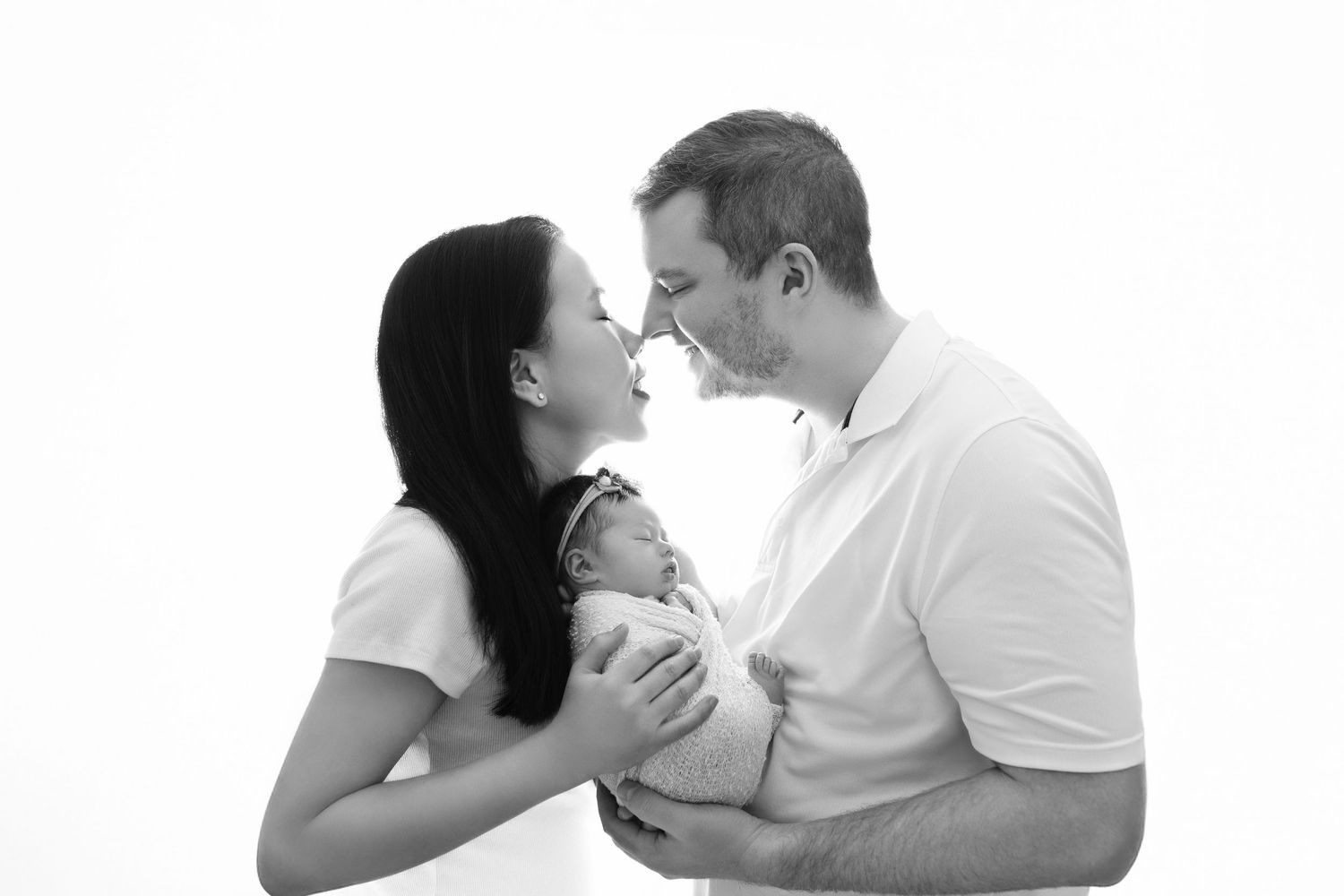 An intimate black and white portrait capturing a tender family moment.