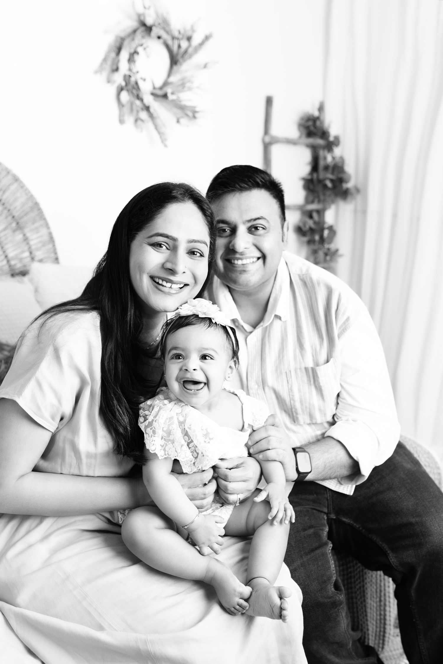 Black and white family portraits showing joyful moments and laughter together.