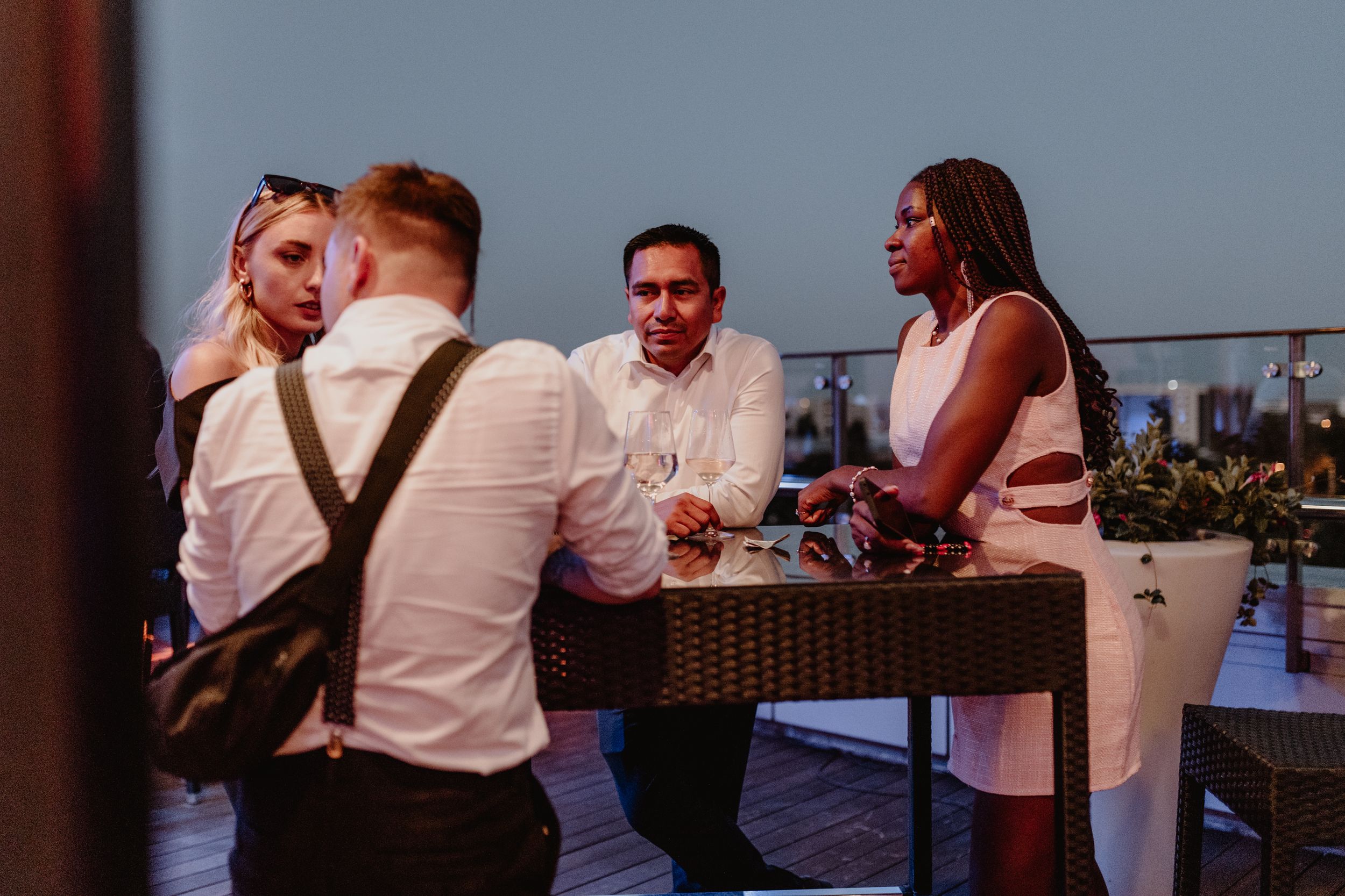 Wedding guests laughing and chatting while enjoying the cool evening air on the terrace of Bon Apetit in Zagreb.