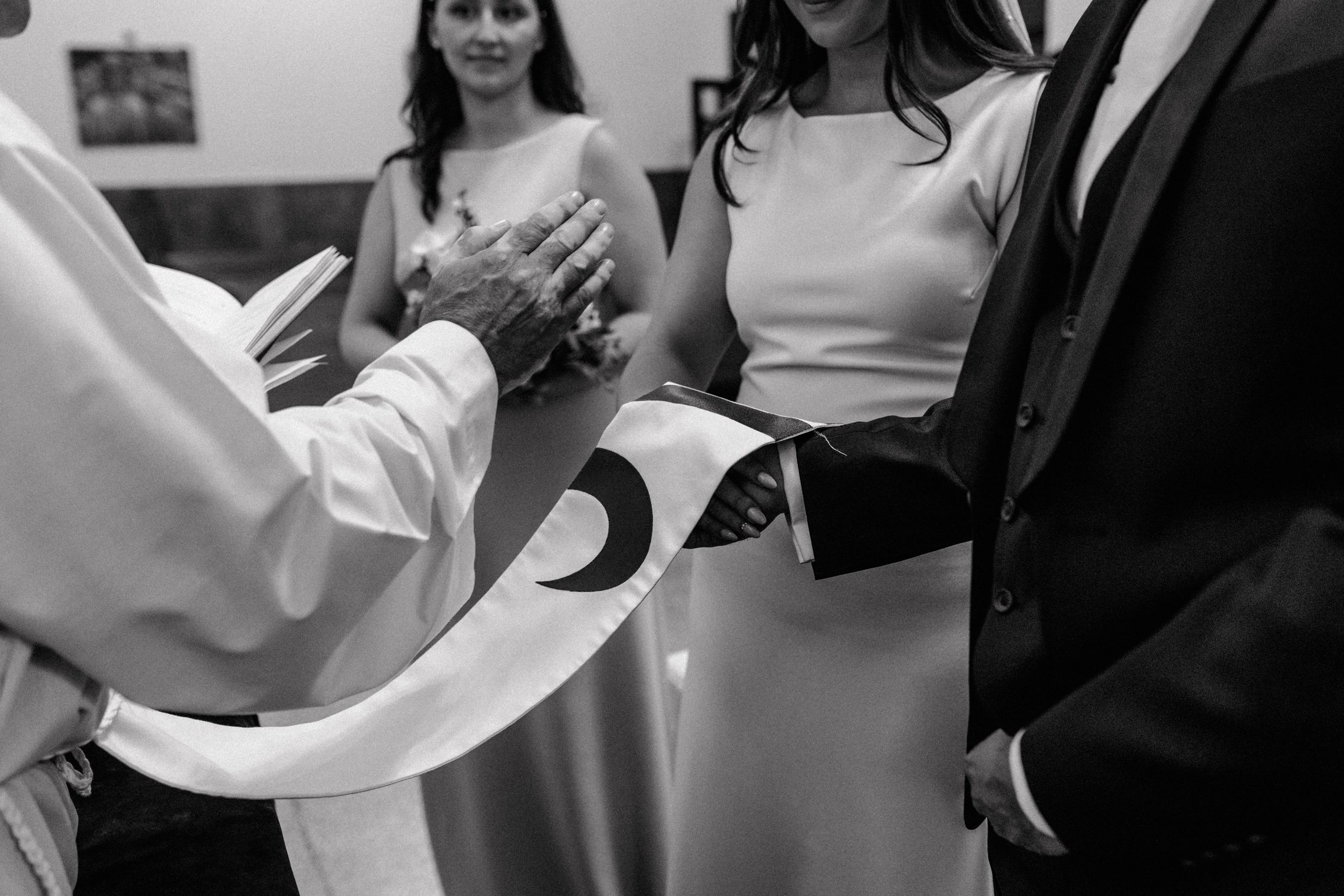Priest blessing the couple during wedding ceremony in St Petar Chruch in Zagreb captured trough wedding photography.