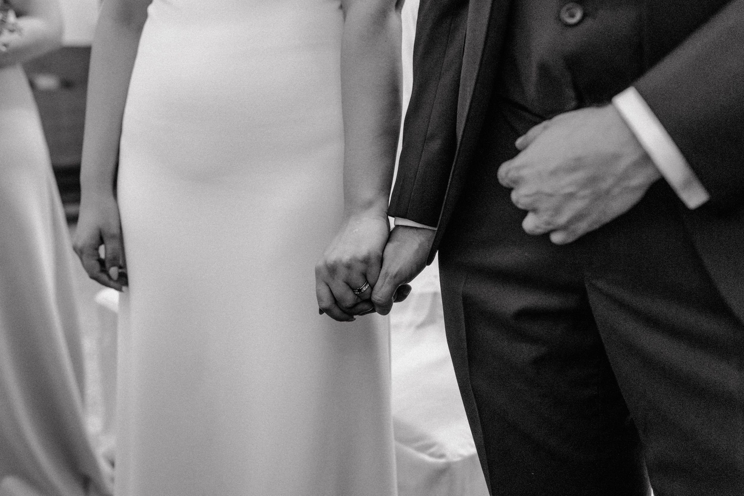 Couple holding hands after exchanging rings during wedding ceremony in st. Petar Church in Zagreb.