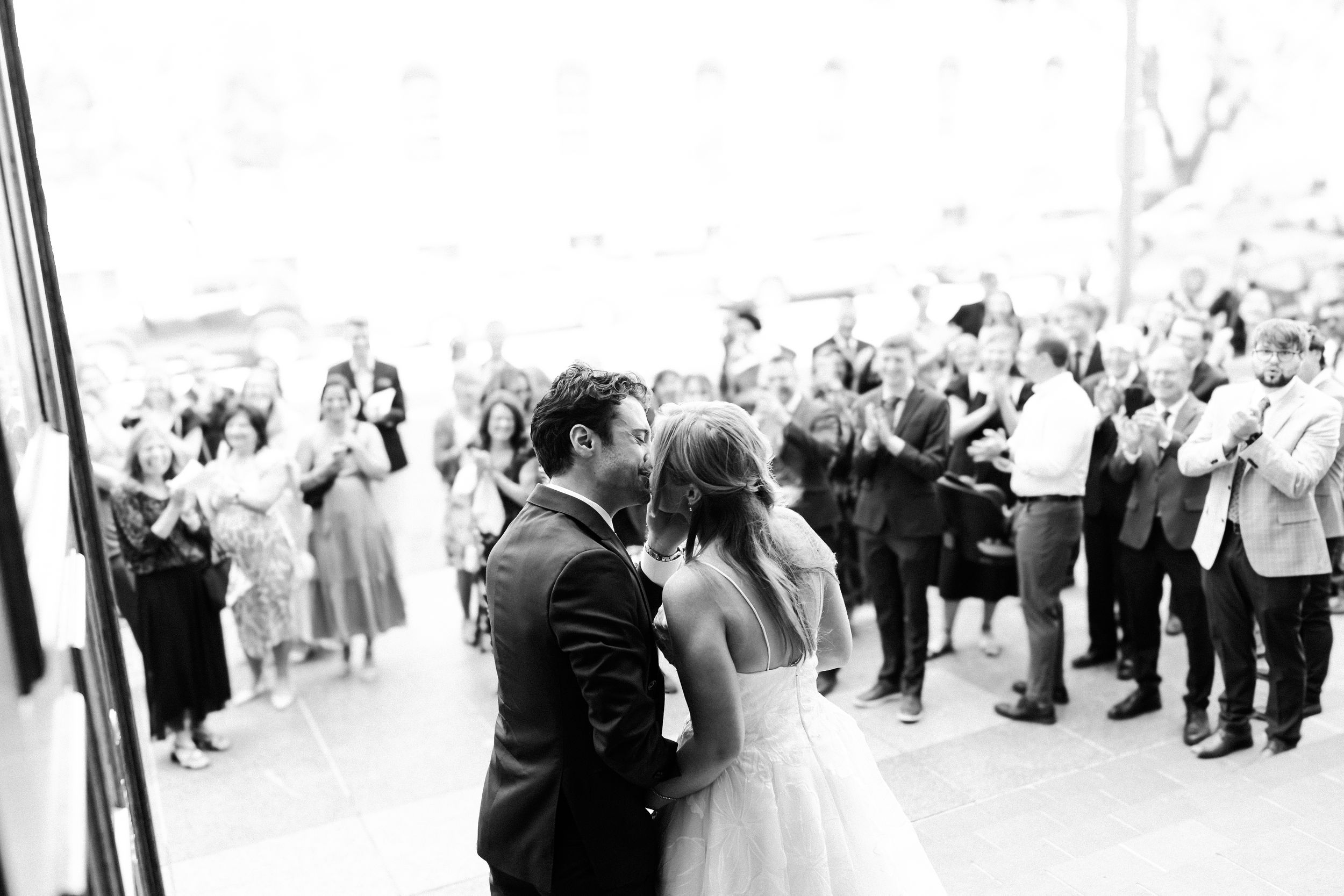 Black and white panoramic photo of a large crowd gathered at an elegant wedding reception celebration.