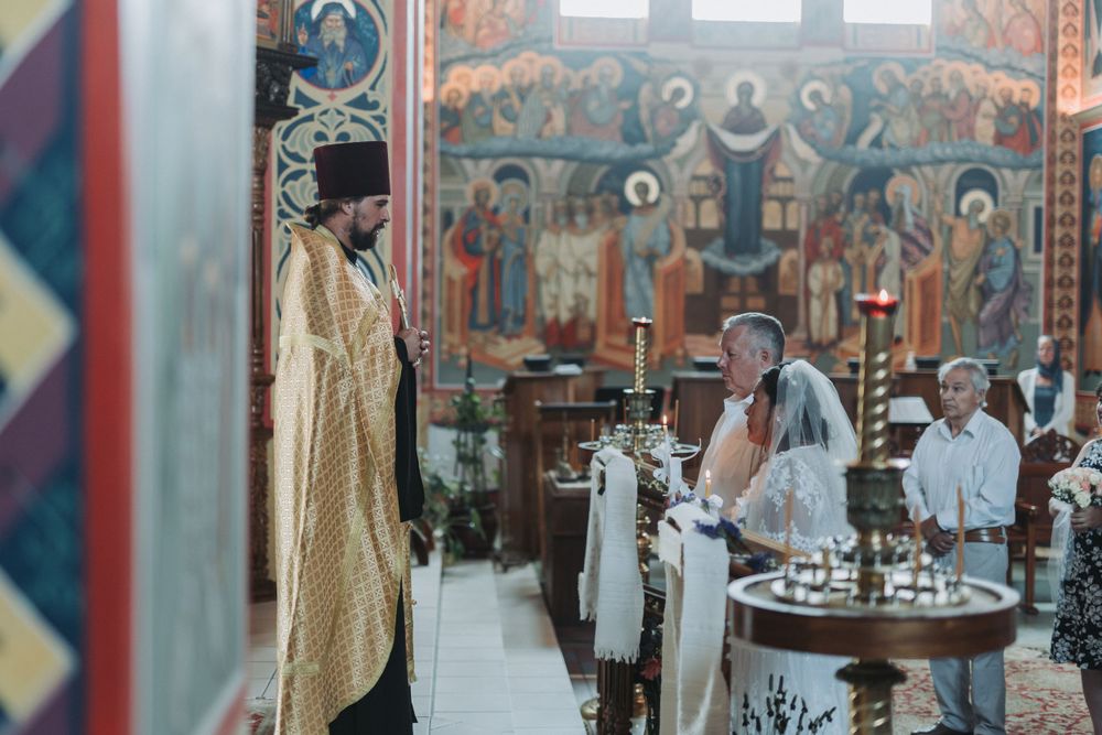 Orthodox church ceremony with golden details and traditional Byzantine architectural elements.