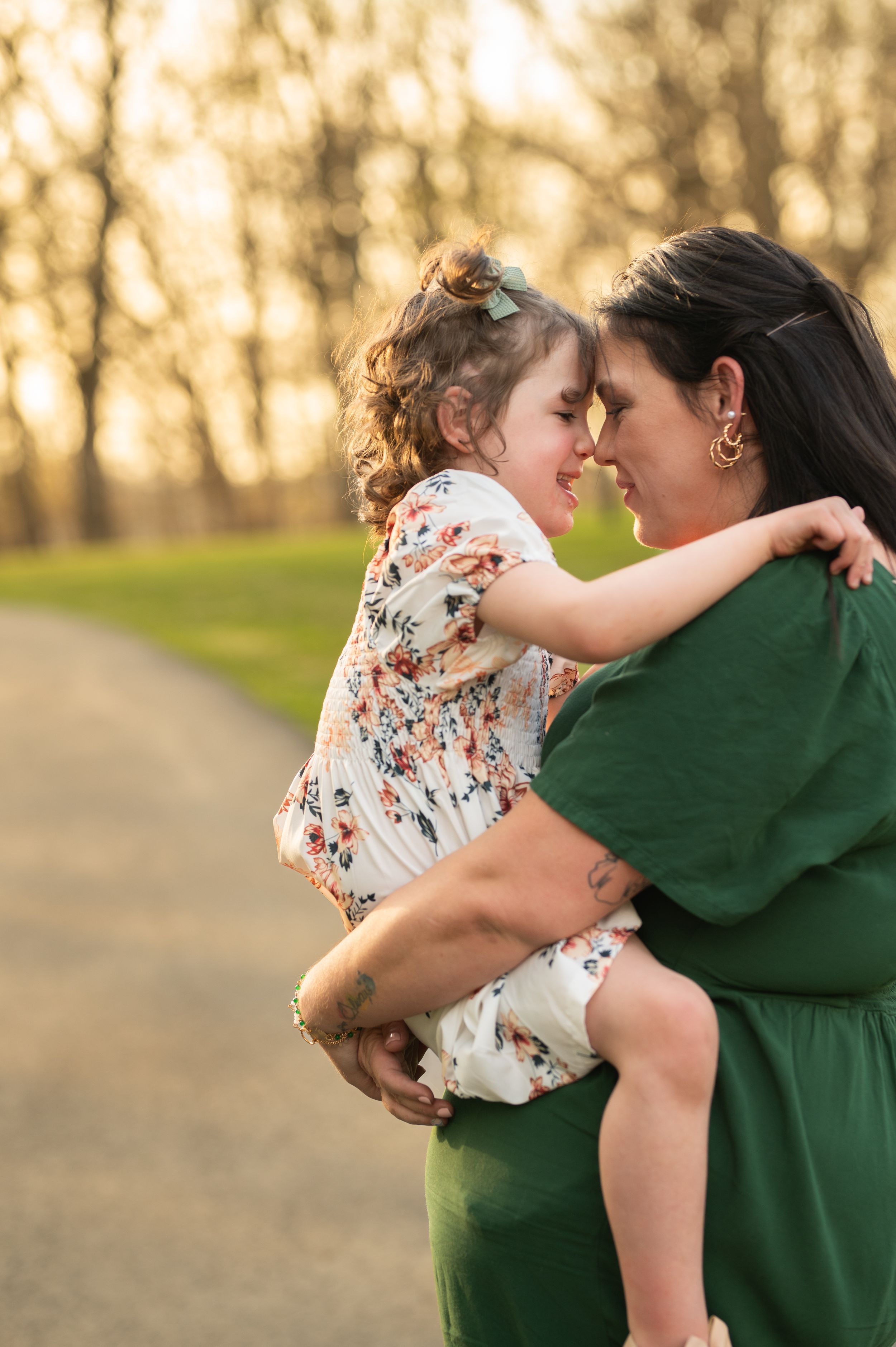 Sweet moment captured between two people during golden hour on a path.