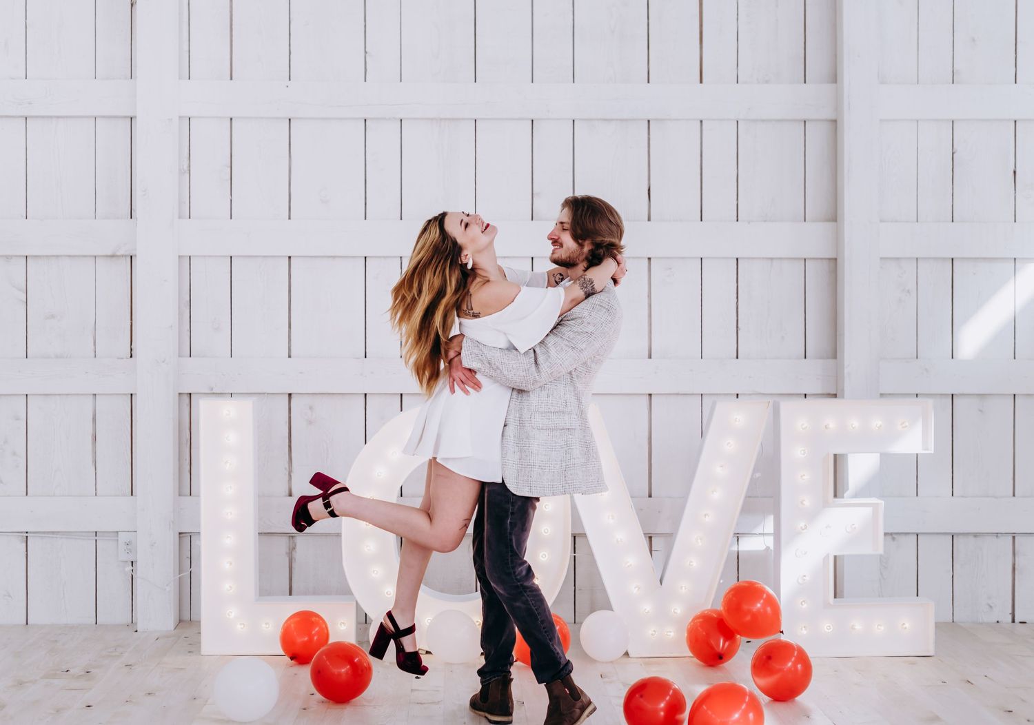 Bride + Groom celebrate their elopement with balloons and marquee lights