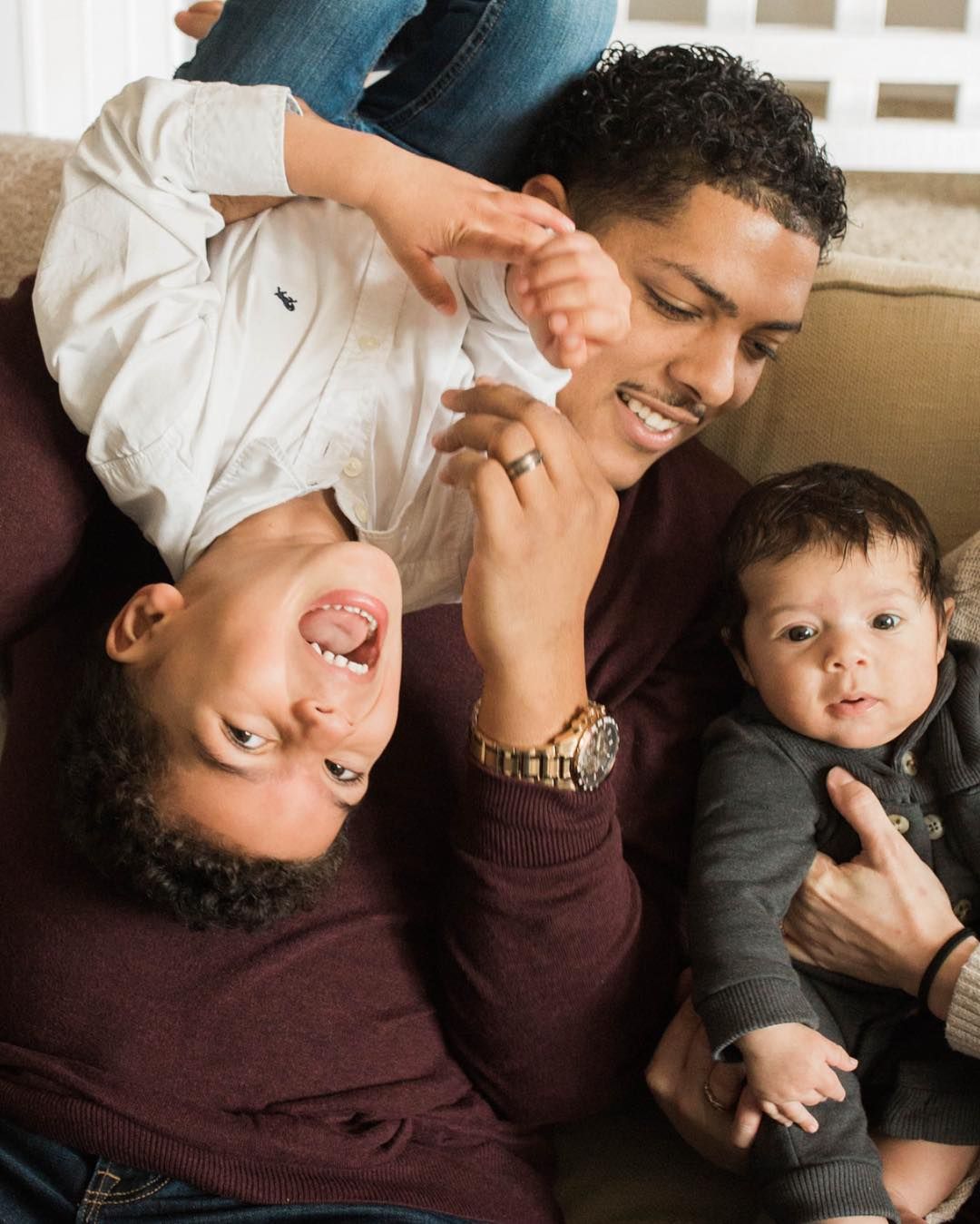 Playful family moment captured with people laying down and laughing together.