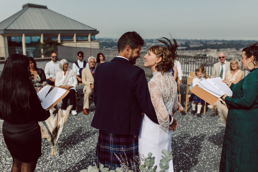 Wedding celebration on stone terrace with guests enjoying the festivities.