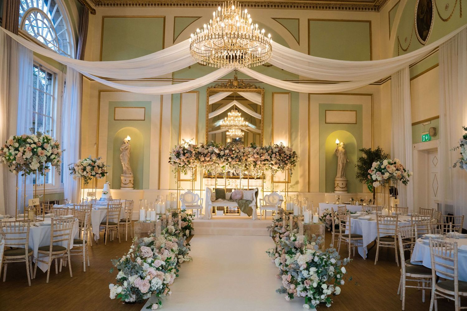 Interior wedding decor, there are tables chairs and flowers