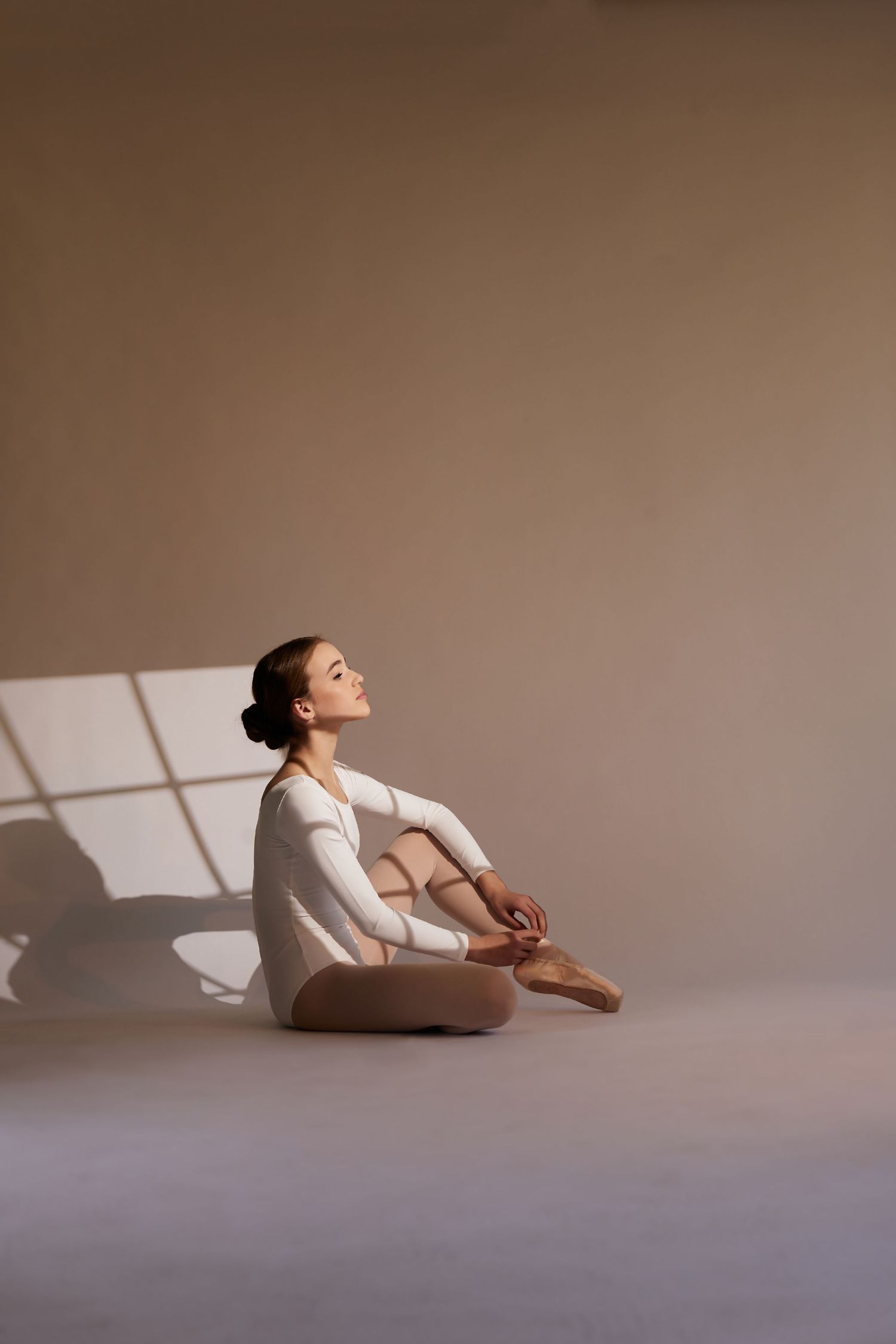 Minimalist portraits showing contemplative poses in soft natural window light.
