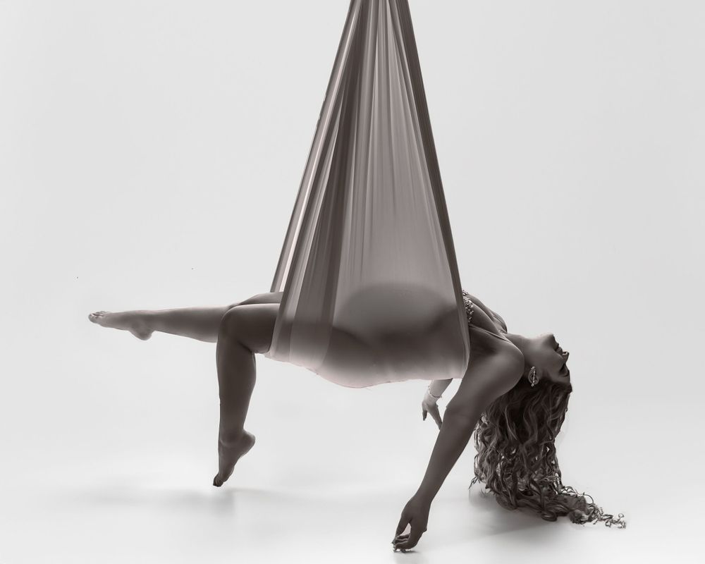 Black and white aerial silk dance pose.