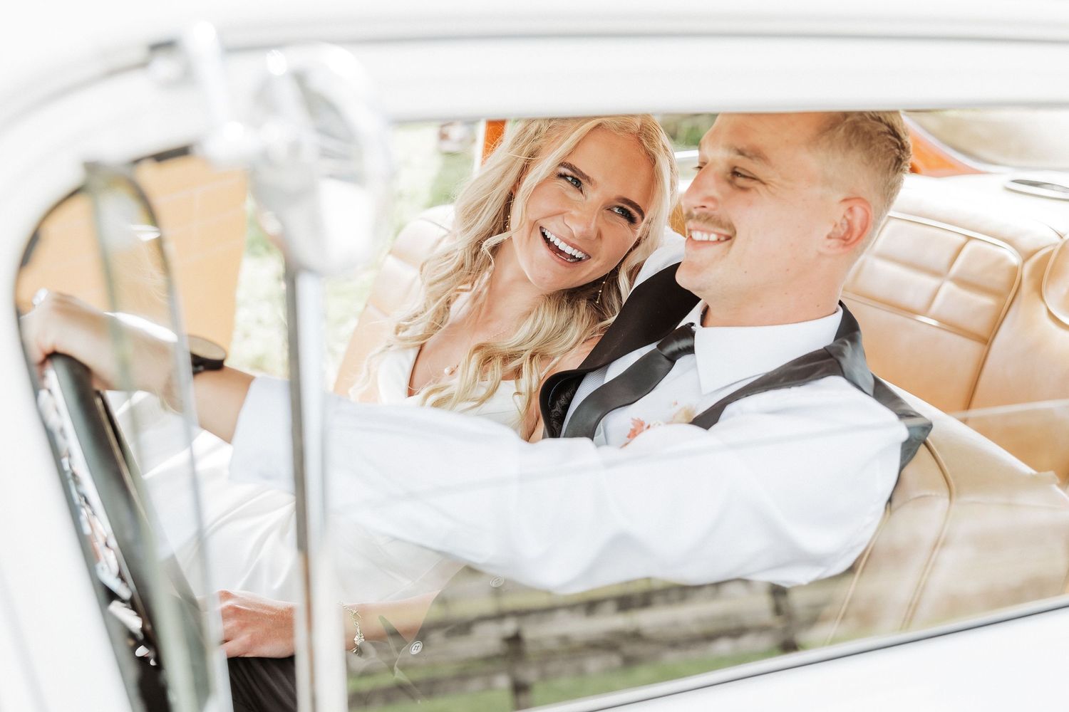 bride looking at groom while he is driving.Backyard wedding at Tauranga Wedding Photographer
