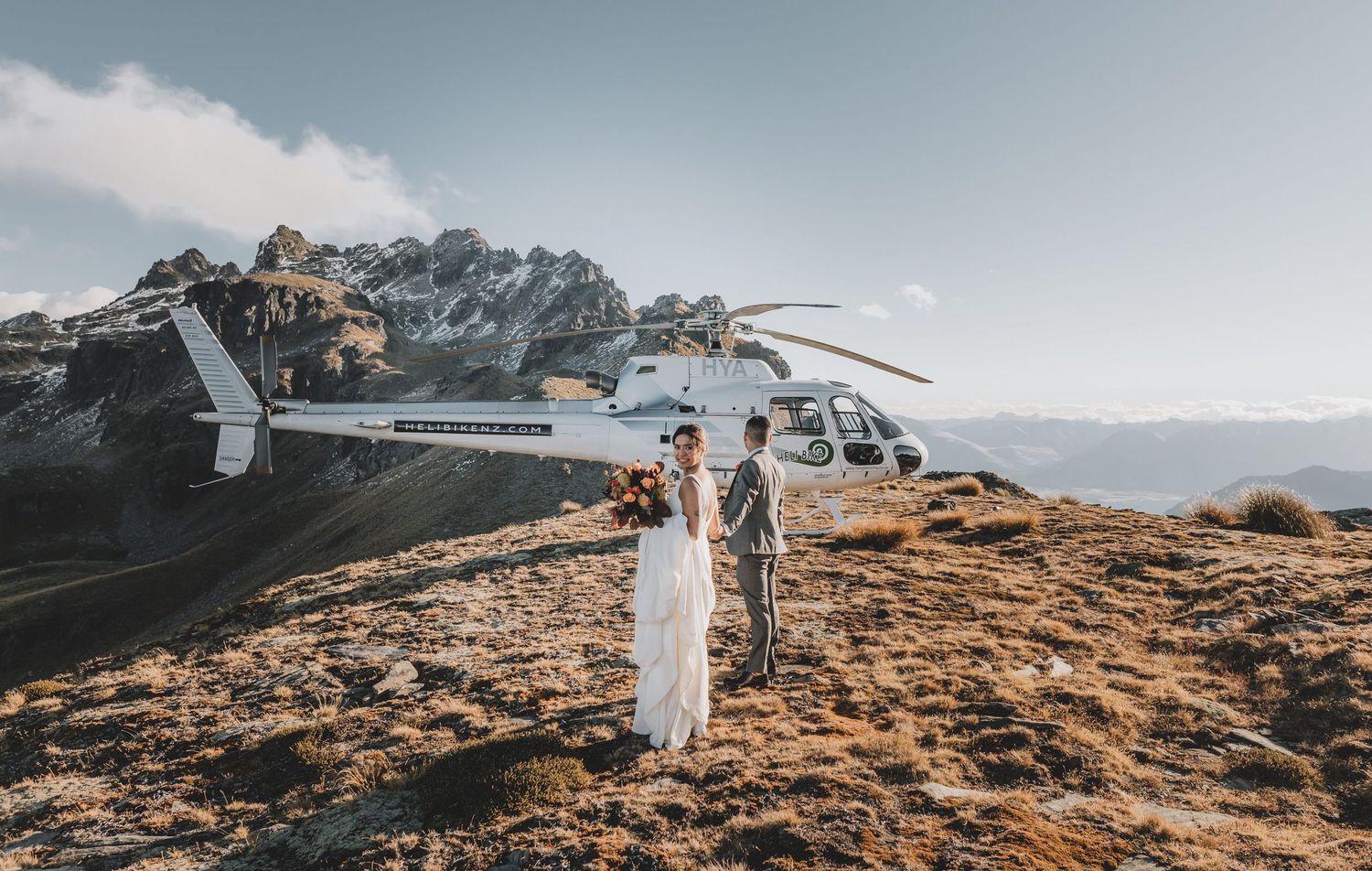 Wedding Couple at the top of Cecil's peak in Queenstown walking back to the helicopter