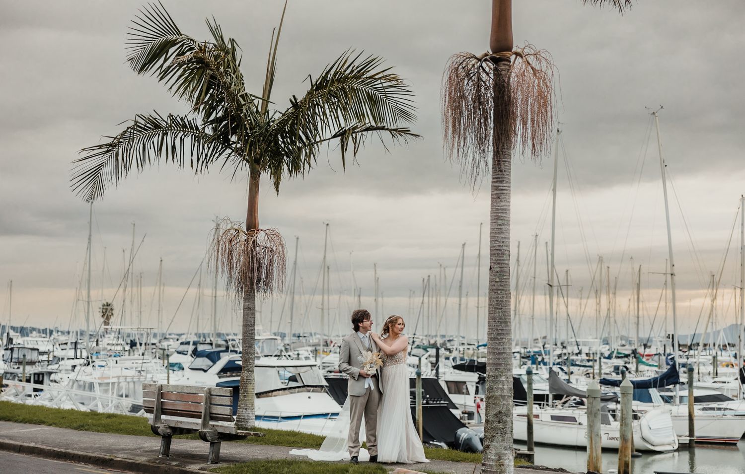 Elopement: Bride and groom at a marina surrounded by boats and yachts. Auckland wedding photographer.