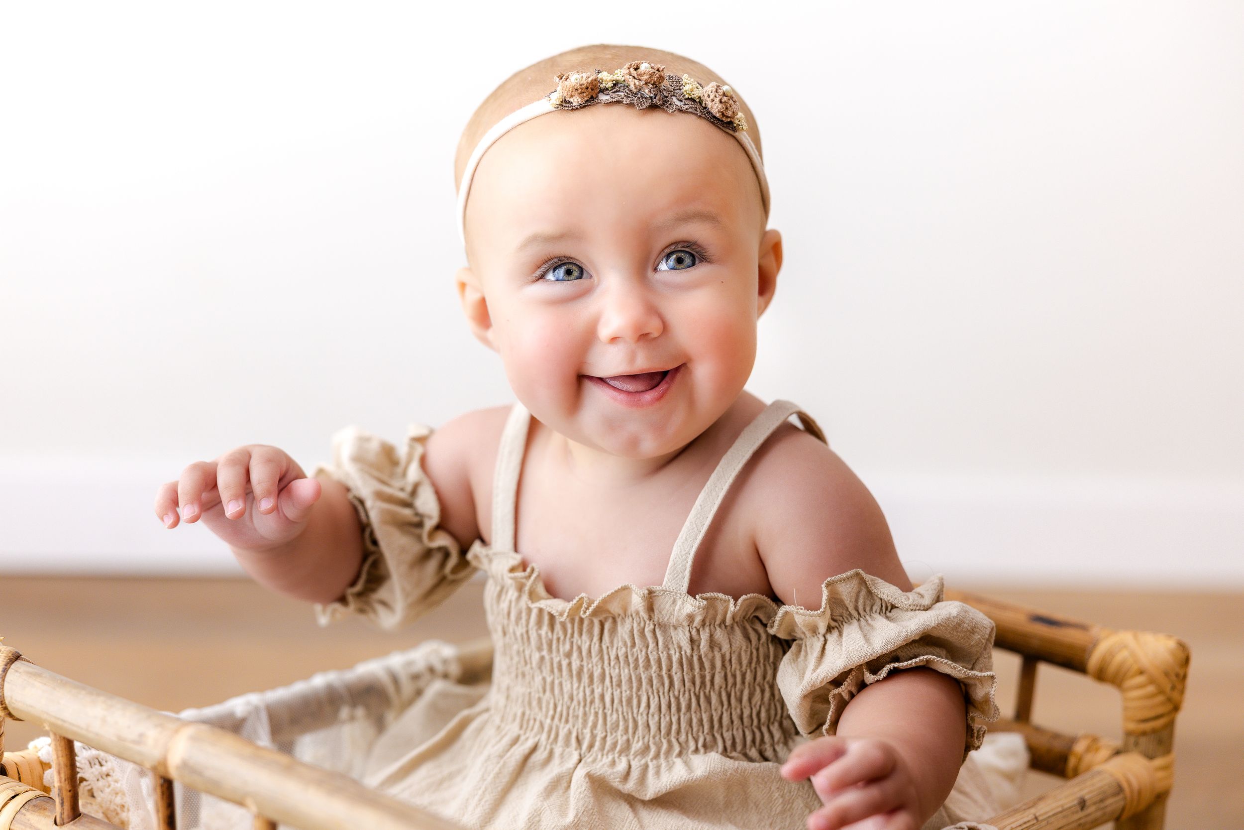 Adorable baby in neutral tones crawls and smiles on white backdrop in professional photo collage.