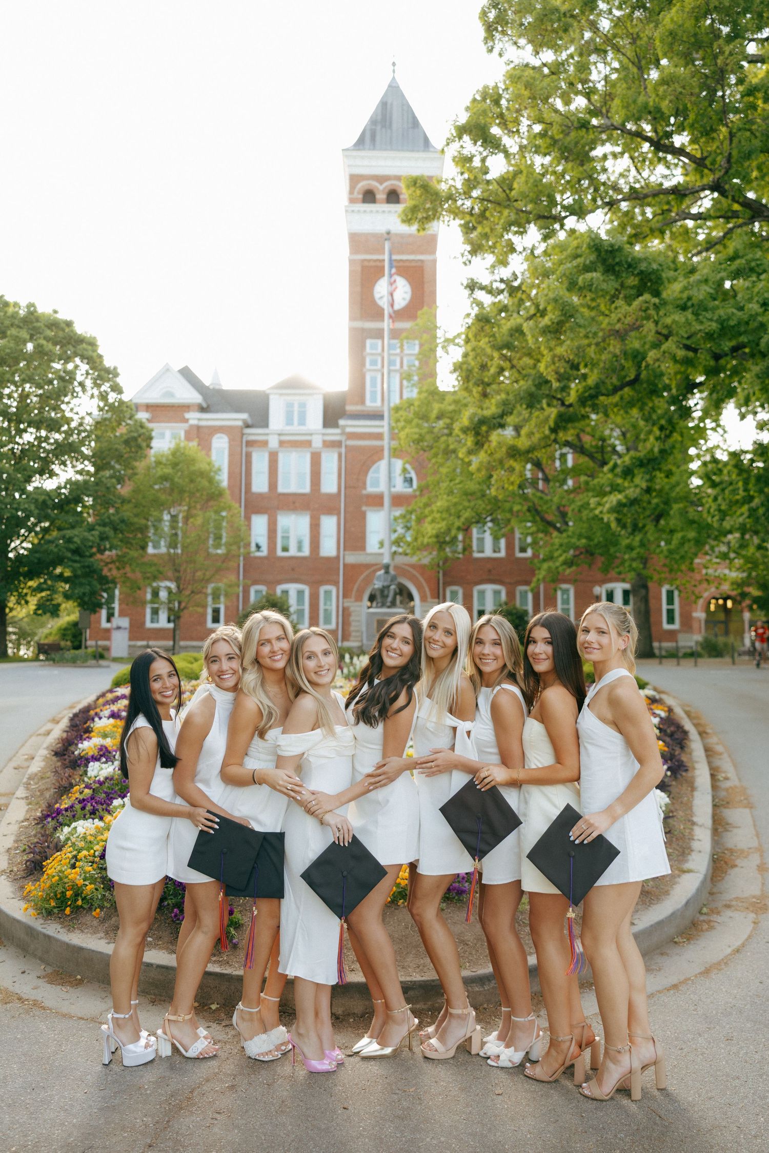 girls at clemson taking graduation photos