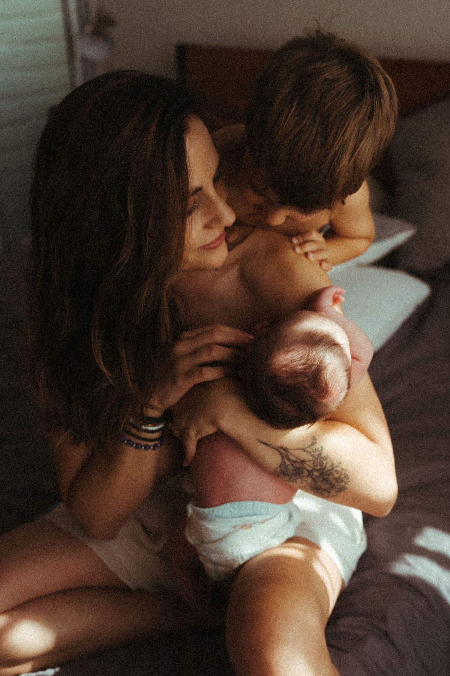 Intimate sequence of tender family moments in soft indoor lighting.