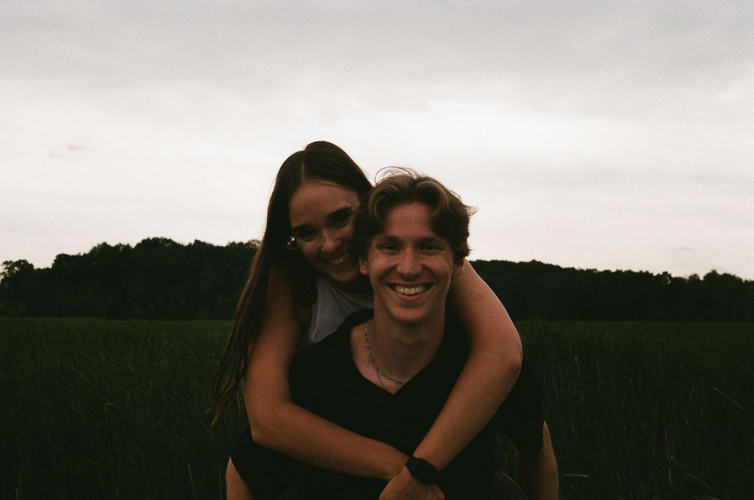 Boyfriend giving his girlfriend a piggyback ride on film in Coon Rapids Minnesota