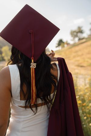 A graduation cap and tassel shown from behind against a natural outdoor setting for graduation and senior photos in Orange County