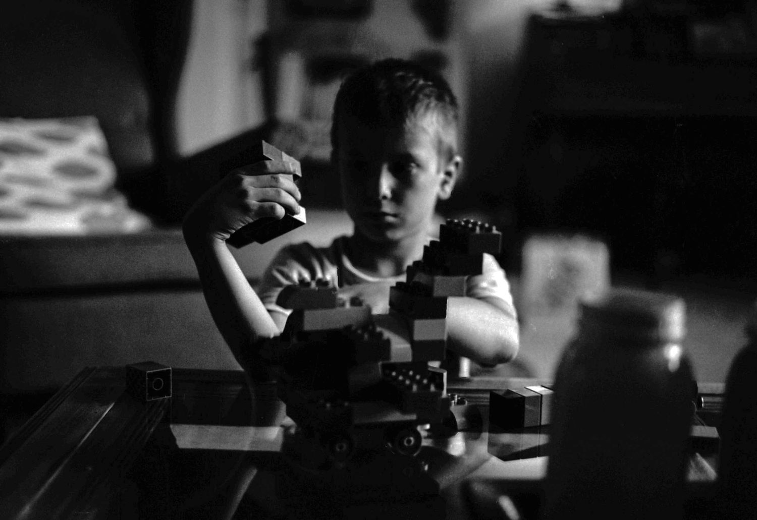 young boy plays with building blocks
