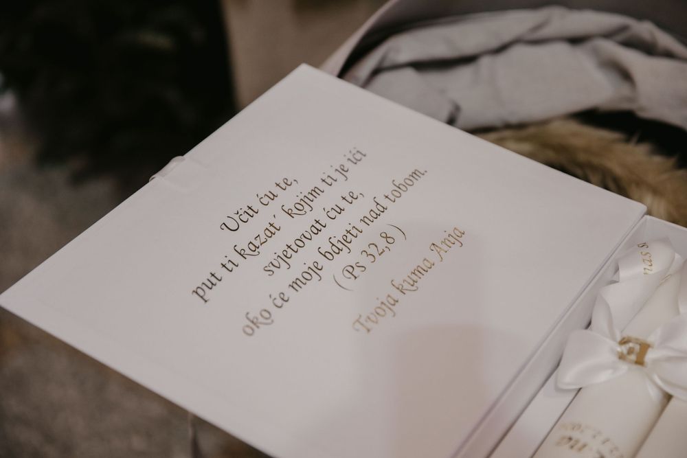 A close-up shot of handwritten text on white paper during a religious ceremony.