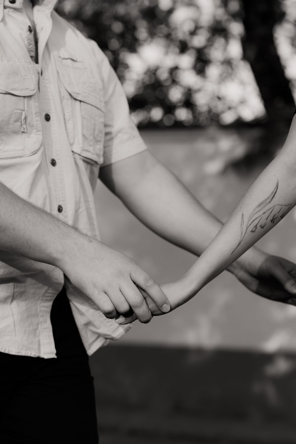 Black and white close-up shots of hands touching and connecting.