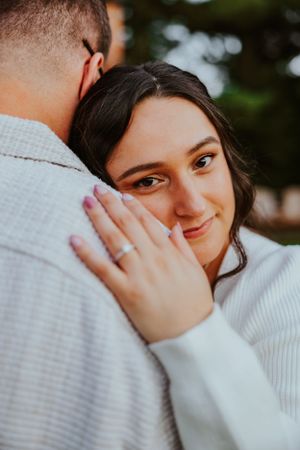 A sweet moment captured between a loving couple embracing in soft natural lighting.