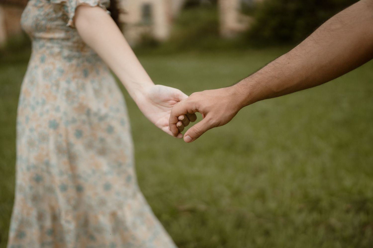 Close-up shots of hands reaching toward each other in a romantic gesture.