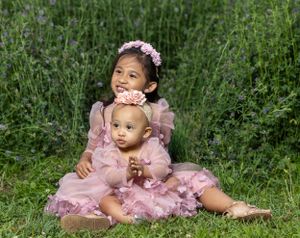 Portrait of children in front of green field.