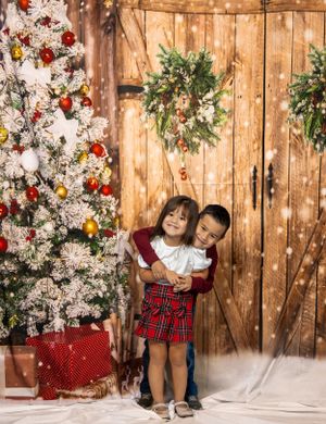 Kids Christmas portrait with festive backdrop.