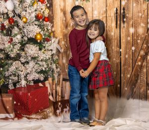 Kids Christmas portrait with festive backdrop.