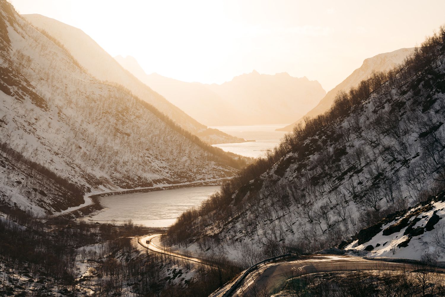 sifjord au coucher du soleil à senja en norvège entre fjords et montagnes enneigées
