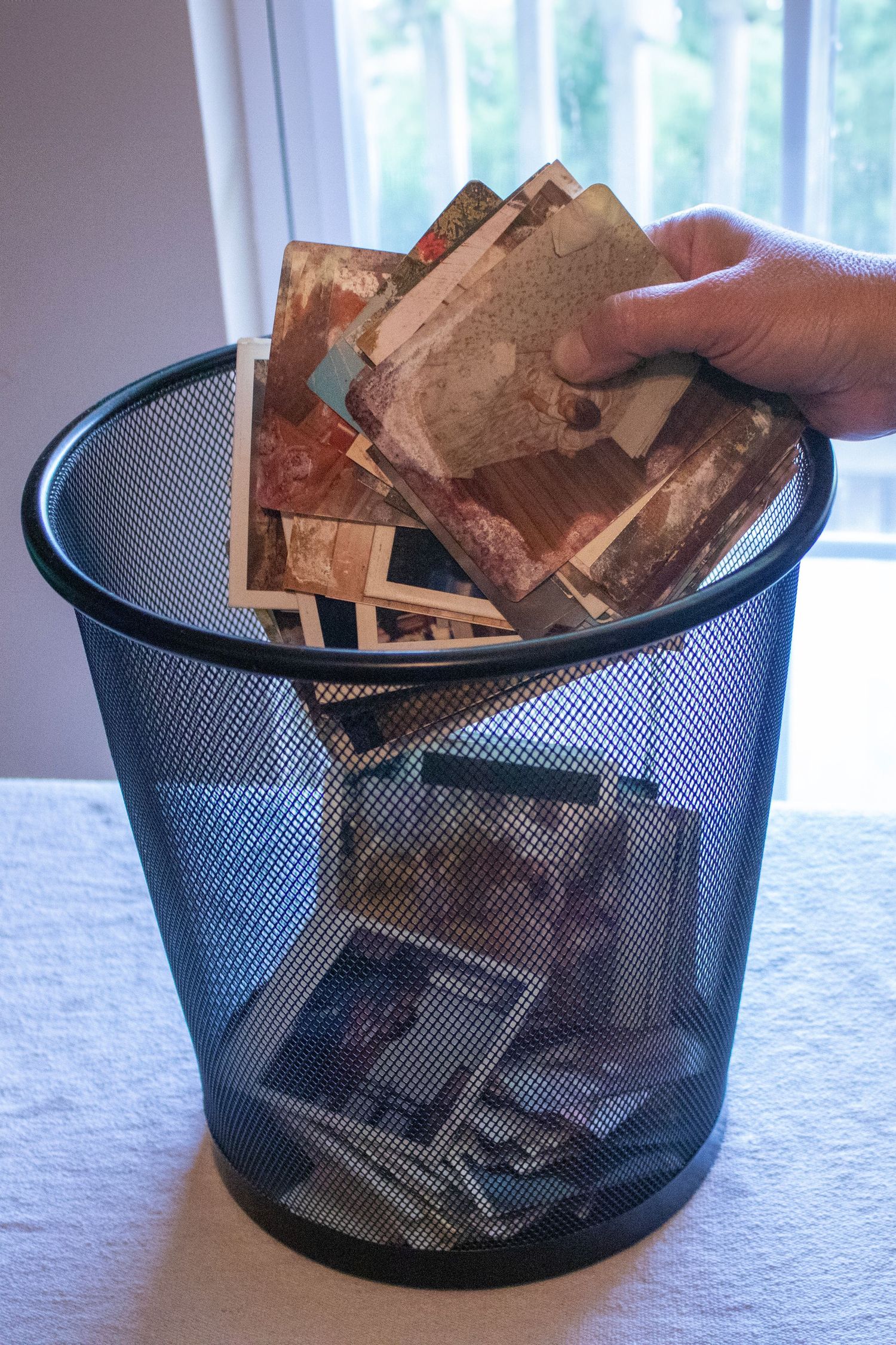Tossing photos in a trash can