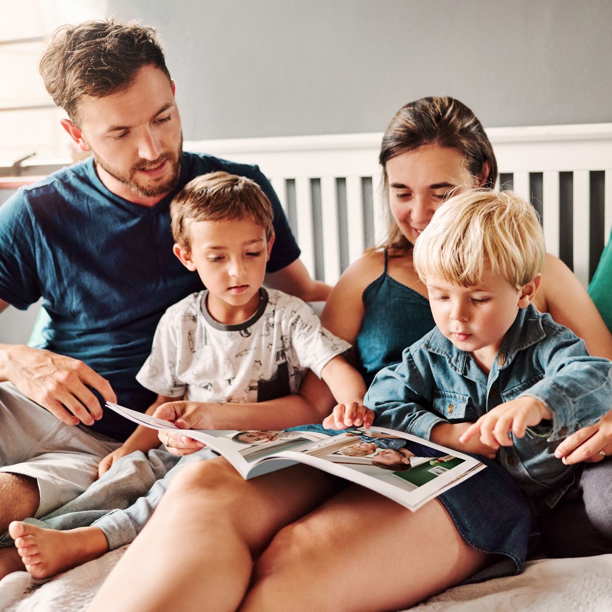 Family looking at their photo books made by FOREVER photos