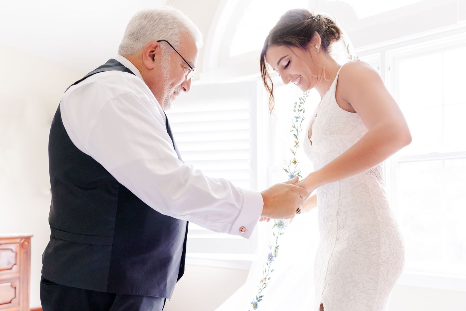 Final wedding dress adjustments being made with care and attention.