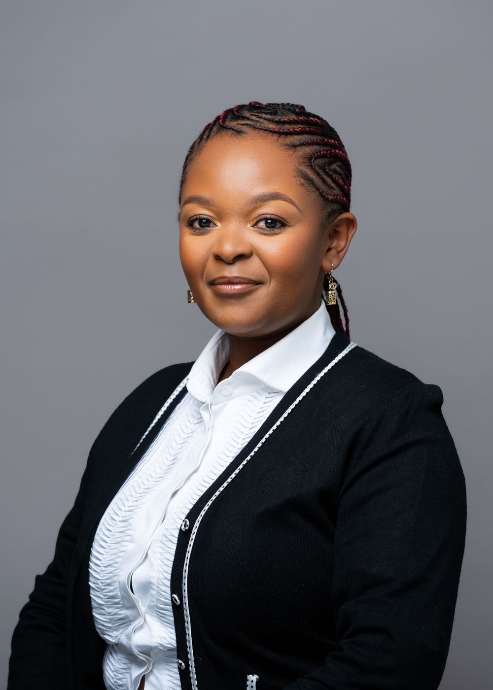 Professional portrait series showing a person in a black blazer and white ruffled blouse against a gray background.