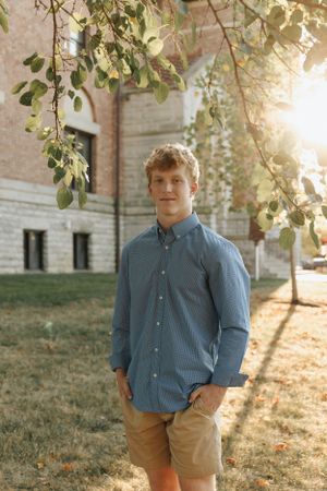 Liberty high school senior in a nice shirt on Ohio Wesleyan campus at sunset.