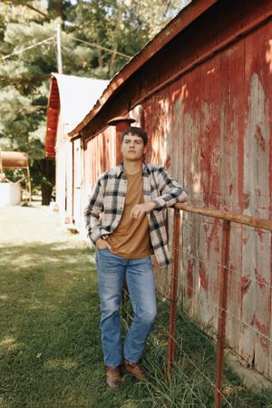 Cool dude posing next to his grandparent’s old barn.