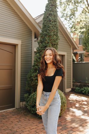Fun and flirty pose of girl for her senior photos around German Village in Columbus, Ohio