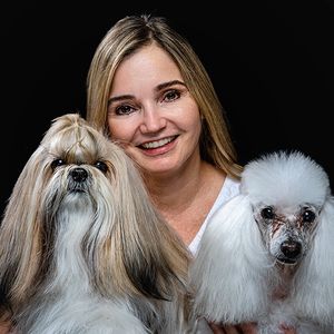 Two elegant show dogs with long white fur posing for portrait.