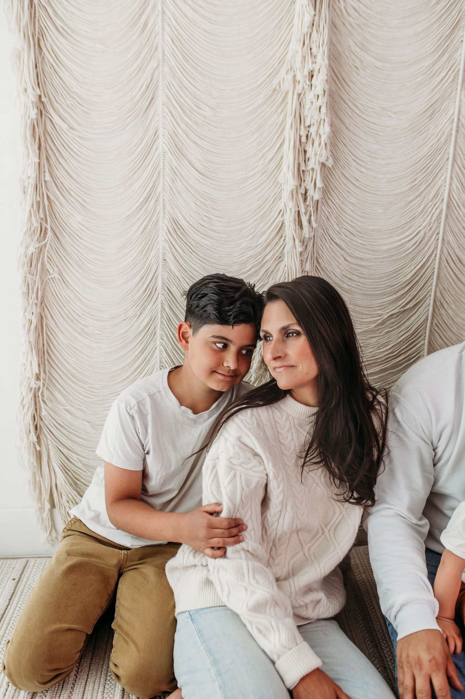 Mother and son sharing a quiet moment on a cozy neutral backdrop