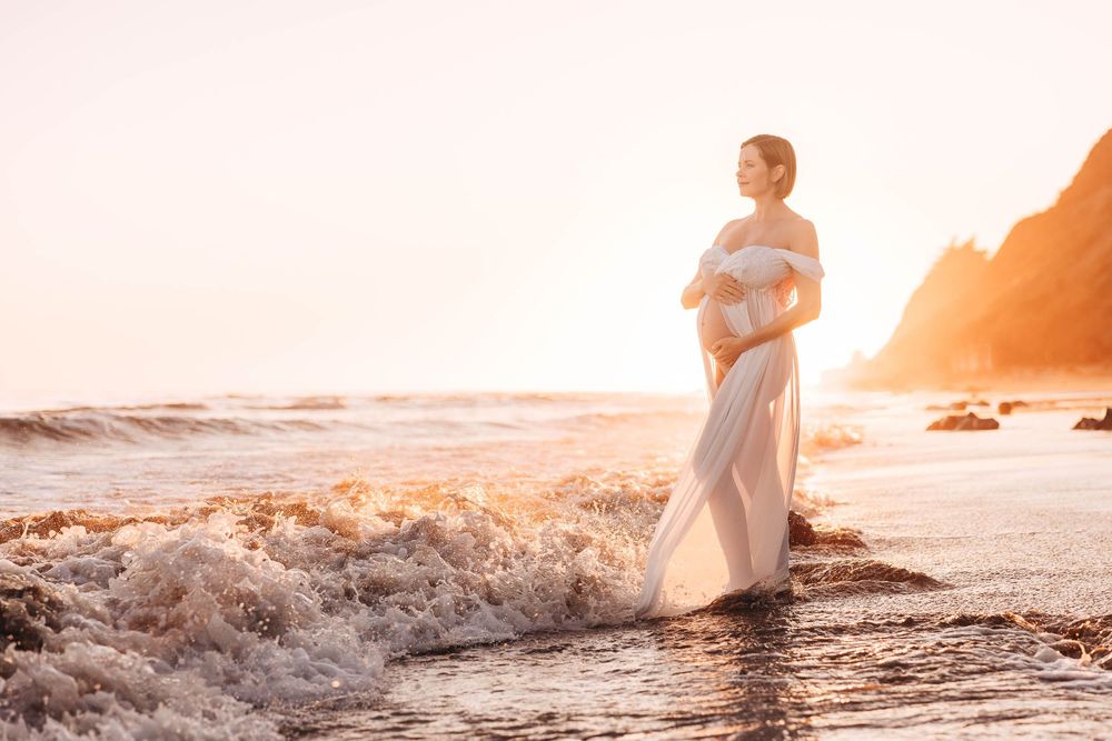 A collection of ethereal beach photographs at sunset with warm golden tones showing silhouettes by the ocean waves.