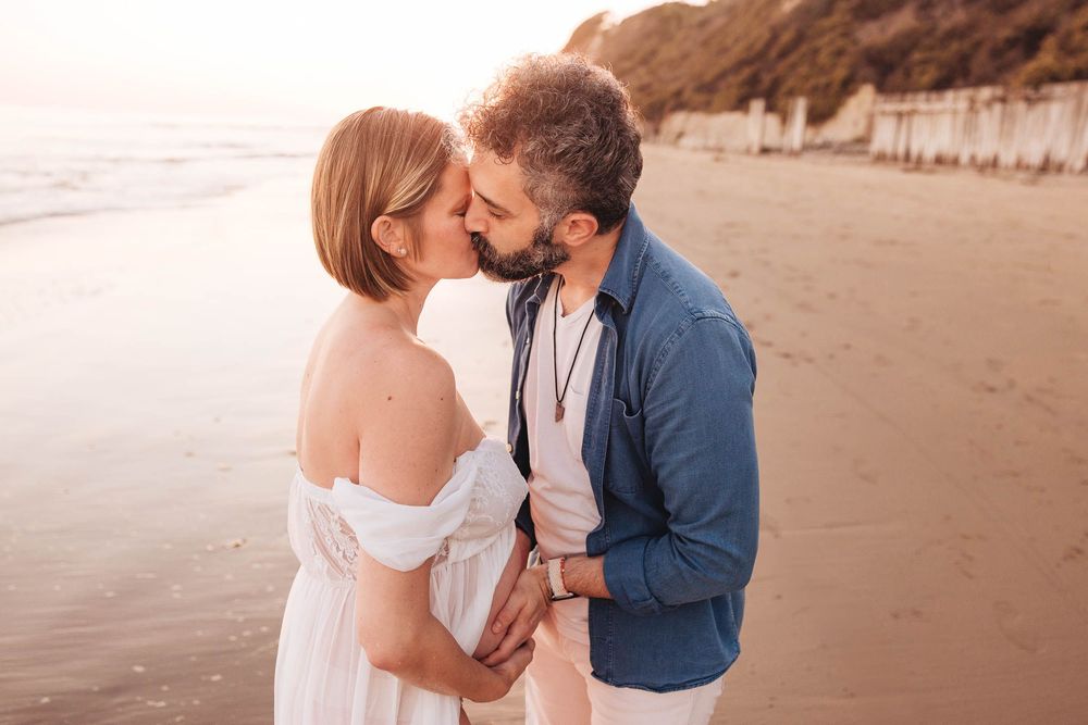 Series of candid romantic moments between couple during sunset beach photoshoot.