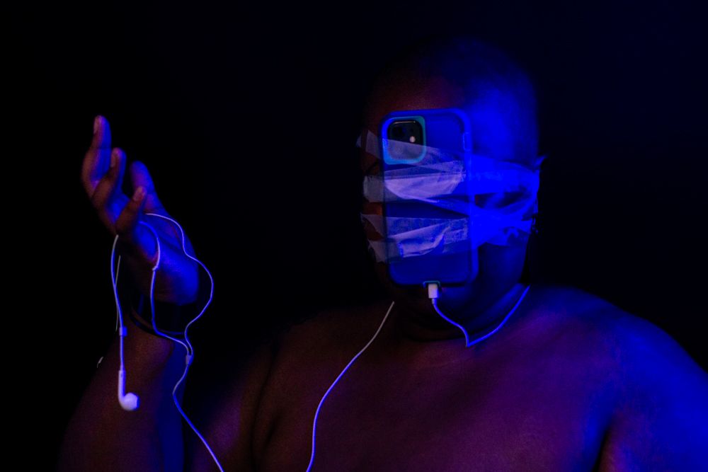 Two silhouettes bathed in dramatic blue lighting with neon line effects creating a futuristic atmosphere.