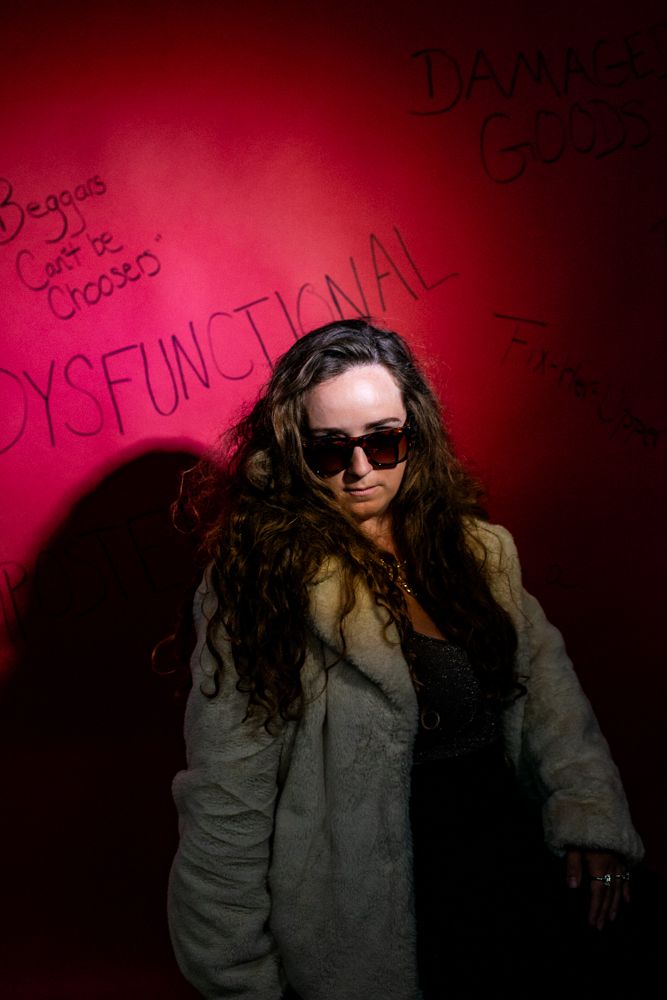 A figure in sunglasses and long hair poses against a dark pink wall in a photo sequence showing different dynamic movements.