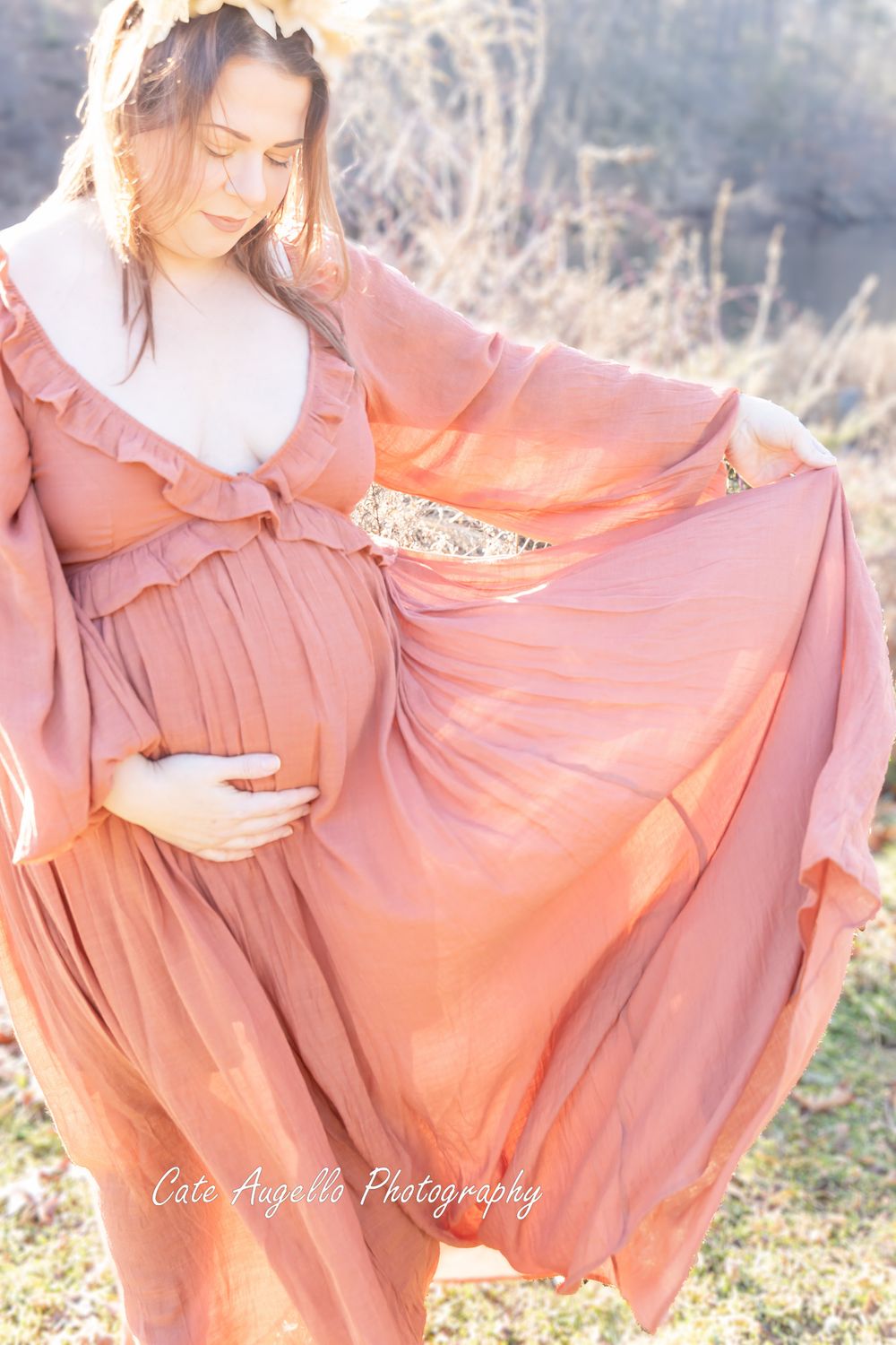 Ethereal maternity photo of a flowing dusty rose dress twirling in soft sunlight against a natural outdoor backdrop.  Manchester, CT